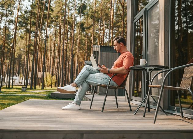 Work from Home Young Man with Laptop Sitting outside Working Online