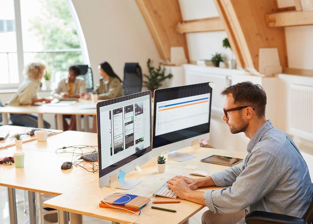 Serious Programmer Sitting His Workplace Using Computers His Work He Developing New Software Office with His Colleagues