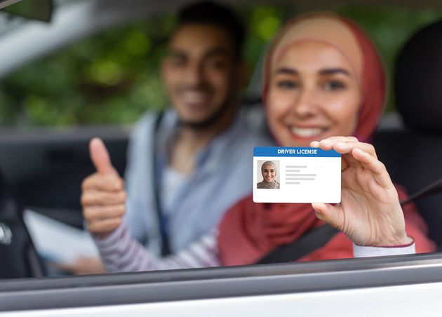 Glad Middle Eastern Male Female Hijab Show Driving License Thumb up Open Window Car