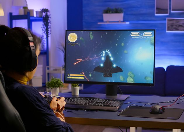 Pro Gamer Playing Space Shooter Online Championship with Modern Graphics Using Wireless Controller