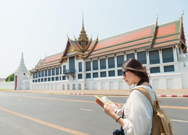 Smiling Pretty Tourist Woman Reading Travel Guidebook Standing Grand Palace Roadside Searching Information Map Bangkok Thailand Travel