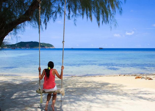 Young Girl Sitting Swing Faces Intense Blue Sea Sandy Beach Island Koh Phangan