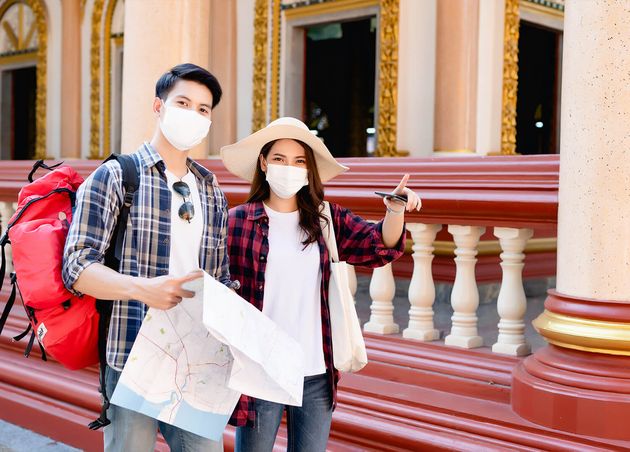 Young Asian Backpacker Couple Beautiful Temple during Vacations Thailand Pretty Woman Wear Sombrero Pointing where They Want Go They Hold Paper Map Smartphone Checking Direction