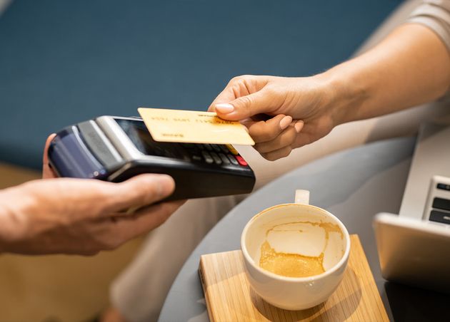 Female Hand Holding Plastic Card Electronic Payment Machine Held by Waiter while Paying Cappuccino Cafe