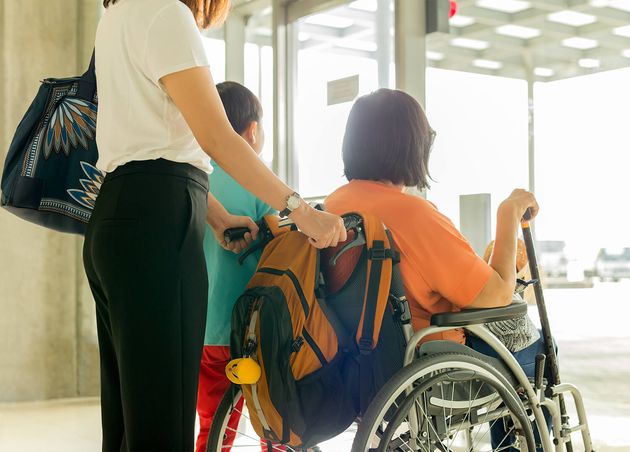 Woman with Son Mother Wheelchair Waiting Boarding International Airport