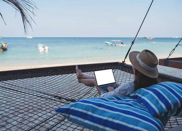Mockup Image Woman Using Typing Laptop Computer with Blank Desktop Screen while Lying down Hammock Beach