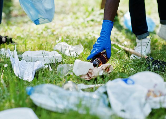 Hand African American Man Picking up Bottle into Garbage Bags while Cleaning Area Park Africa Volunteering Charity People Ecology Concept
