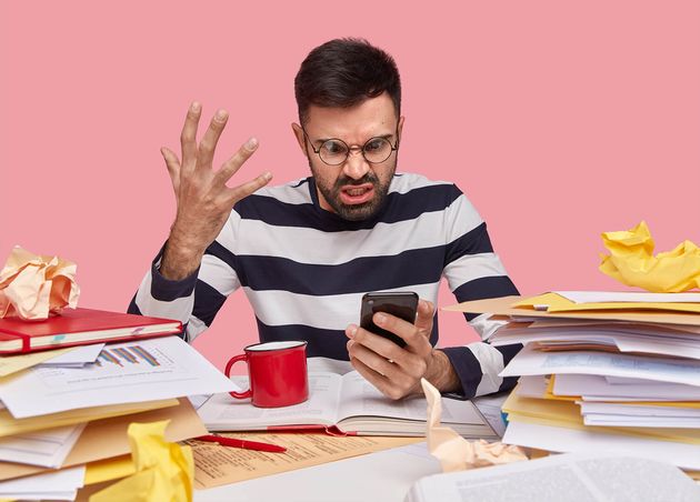 Man Striped Shirt Sitting Desk with Documents