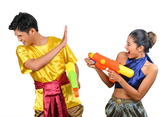 Young Couple Enjoy with Water Gun Songkran Festival