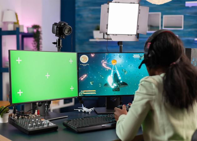 Professional African E Sports Player Streams Championship Using Computer with Chroma Key Gamer Using Pc with Greenscreen Isolated Desktop Streaming Space Shooter Video Games