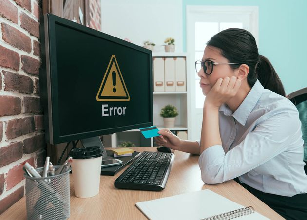 Beautiful Young Office Worker Holding Credit Card Looking Computer Thinking about E Commerce System Error Problem Solution