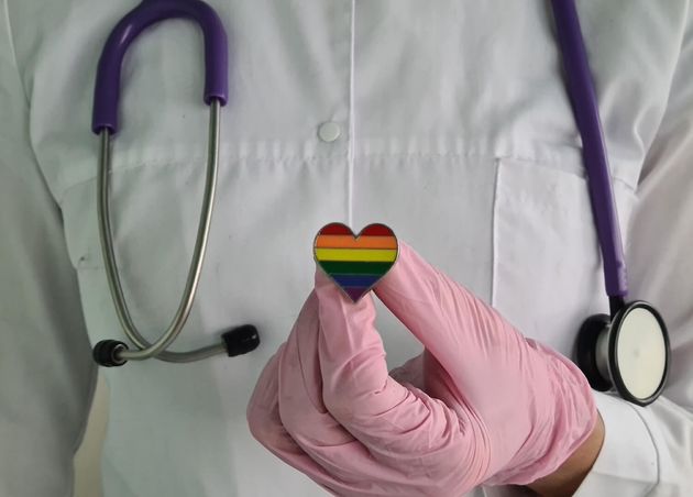 Woman Doctor with Lgbt Heart Flag Hand Clinic