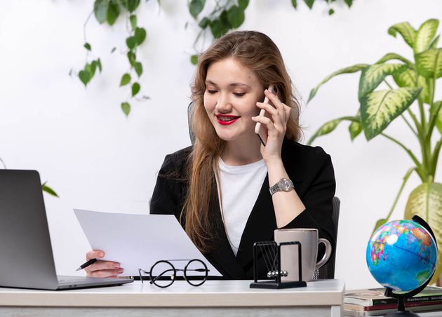 Front View Young Beautiful Lady White Shirt Black Jacket Using Her Laptop Front Table Smiling Talking Phone Working with Documents