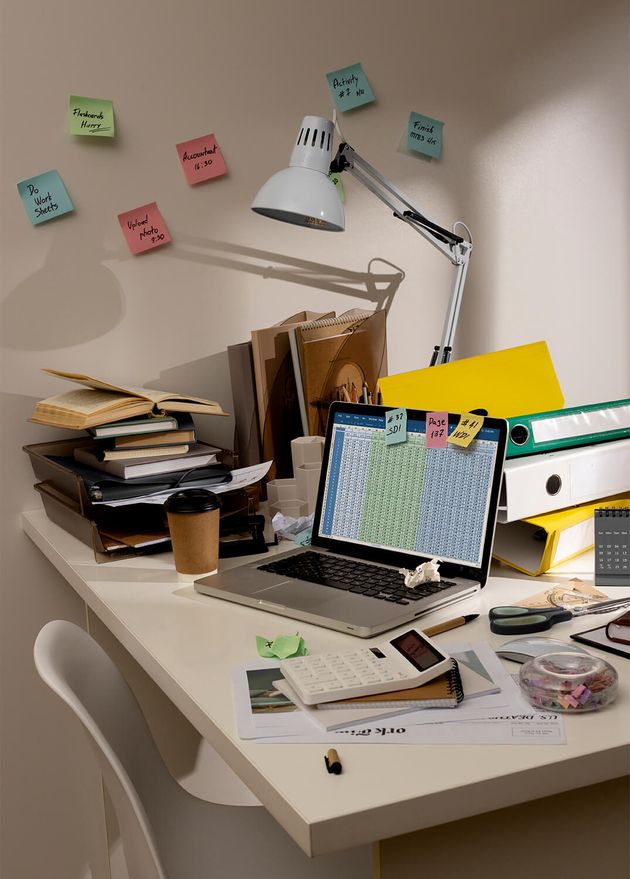 View Messy Office Workspace with Laptop