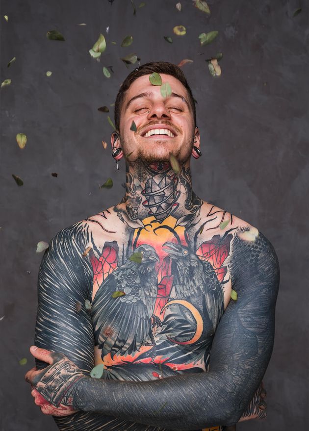 Leaves Falling Smiling Tattooed Young Man with His Arms Crossed