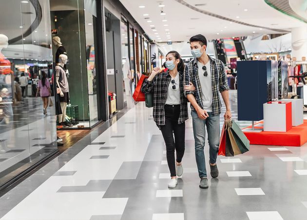 Young Couple Protection Mask Holding Multiple Paper Shopping Bag Walking Corridor Large Shopping Mall