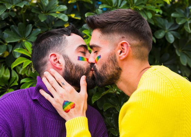 Homosexual Couple Kissing Garden