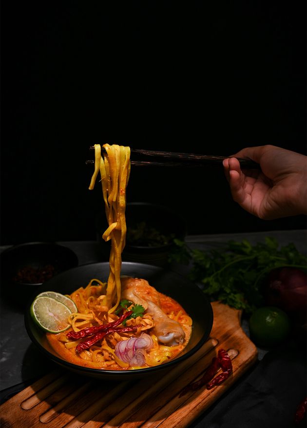 Female Using Chopsticks Eat Her Khao Soi Kai Northern Thai Curry Noodles