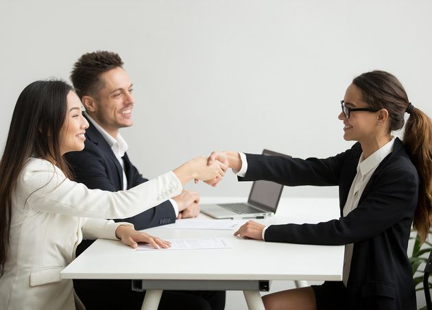 Smiling Diverse Businesswomen Shake Hands Group Meeting Deal Concept
