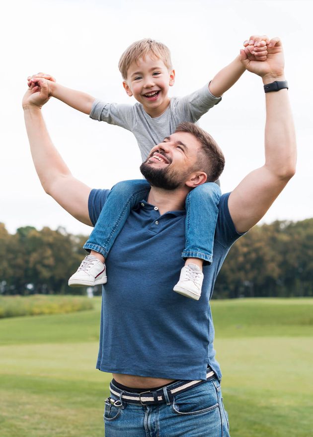 Father Holding His Son His Shoulders Front View