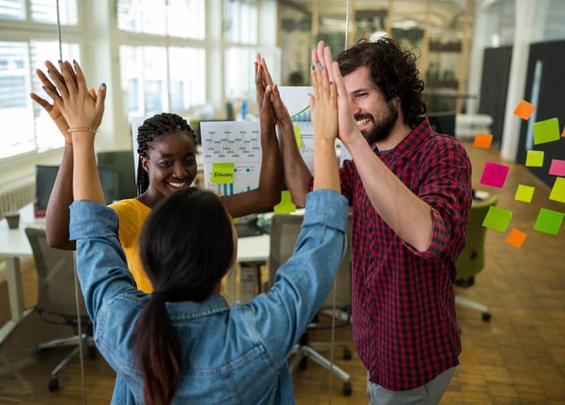 Group Graphic Designers Giving High Five Each Other