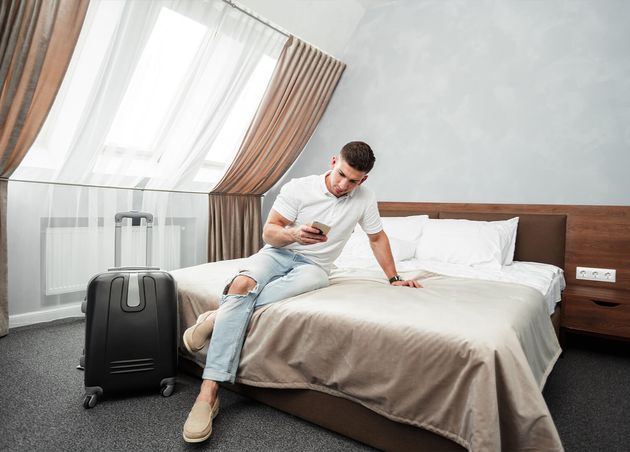 Man Using Smartphone Hotel Room