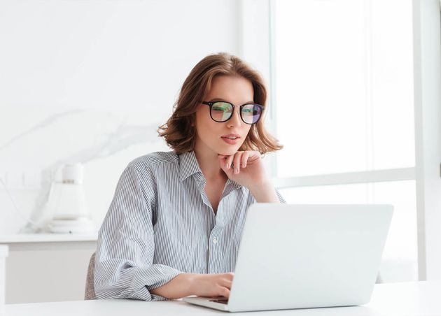 Charming Businesswoman Glasses Striped Shirt Working with Laptop Computer while Siting Home