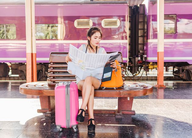 Travel by Train Asian Girl with Orange Pink Bag during Holidays