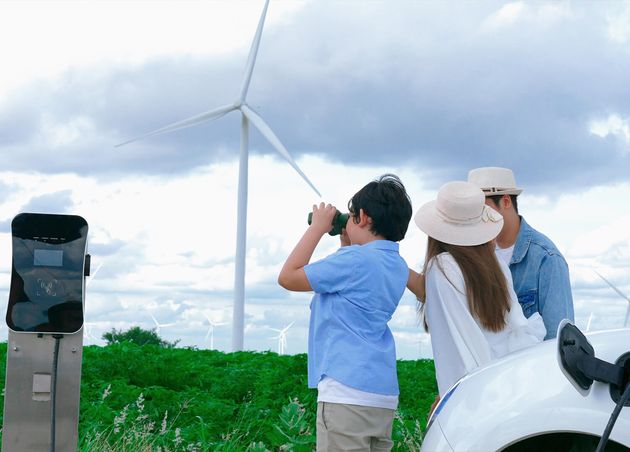 Concept Progressive Happy Family Enjoying Their Time Wind Farm with Electric Vehicle Electric Vehicle Driven by Clean Renewable Energy from Wind Turbine Generator Charging Station