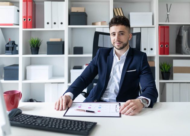 Young Man Sitting Office Computer Desk Working with Documents