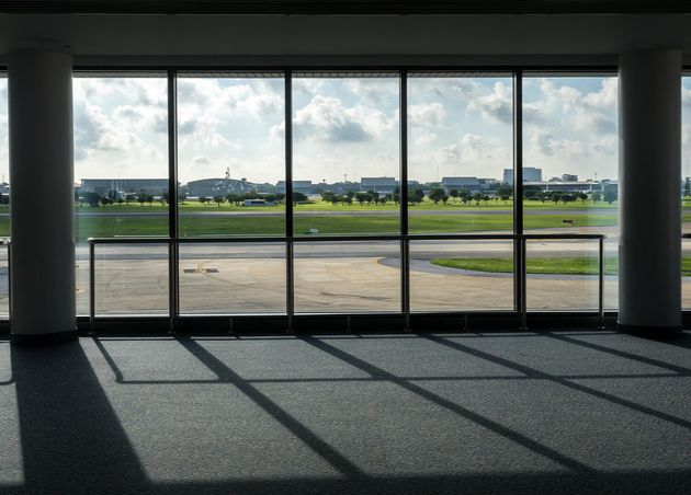 Warm Sunlight through Mirrors Terminal Gateway Building with Runway View