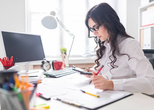 Young Girl Is Sitting Office Desk Working with Calculator Documents