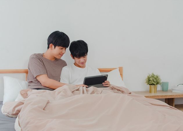 Asian Gay Couple Using Tablet Home Young Asian Lgbtq Men Happy Relax Rest Together after Wake up Check Mail Social Media Lying Bed Bedroom Home Morning